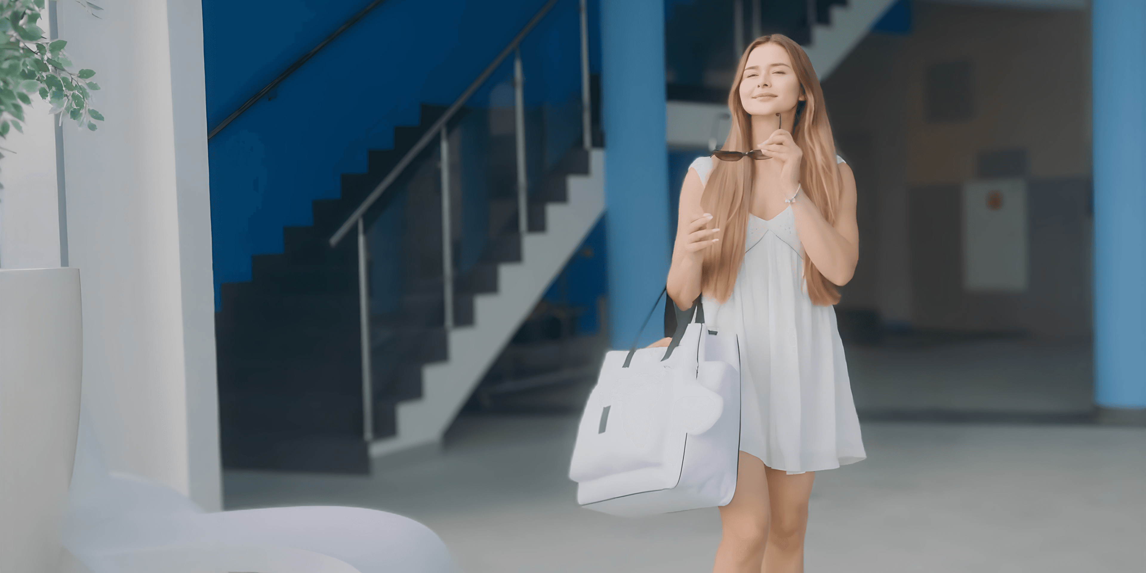 Person in a white dress holding a shopping bag